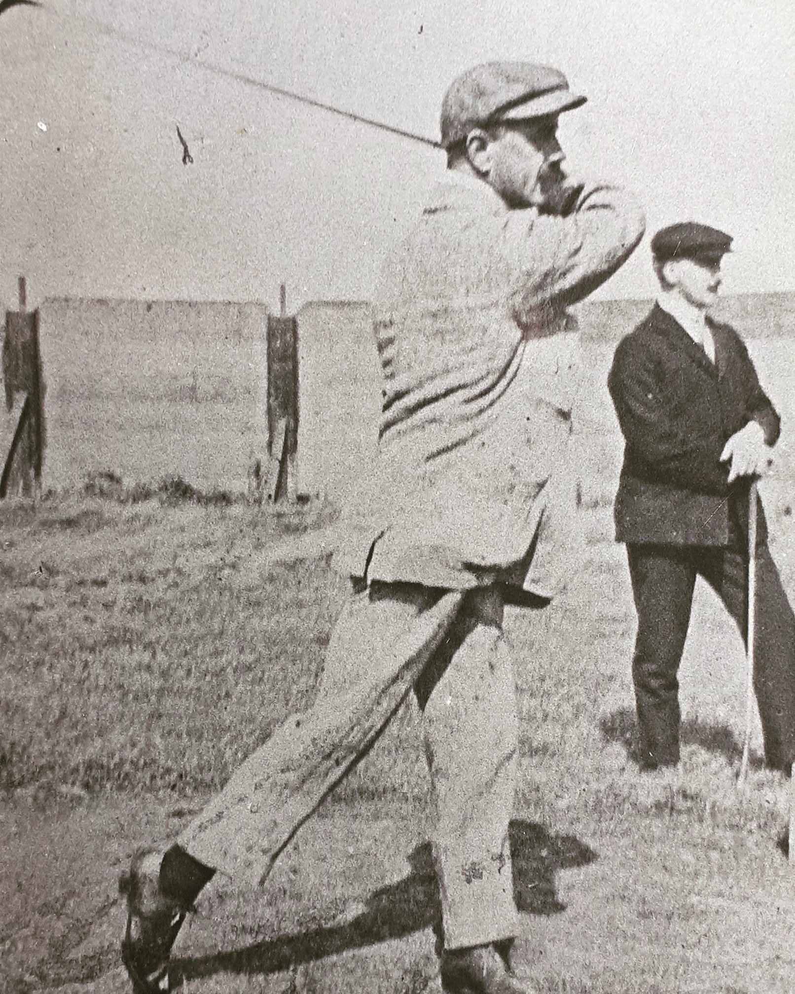 Unnamed golfer vintage photo of a golfer with a cap swinging a club